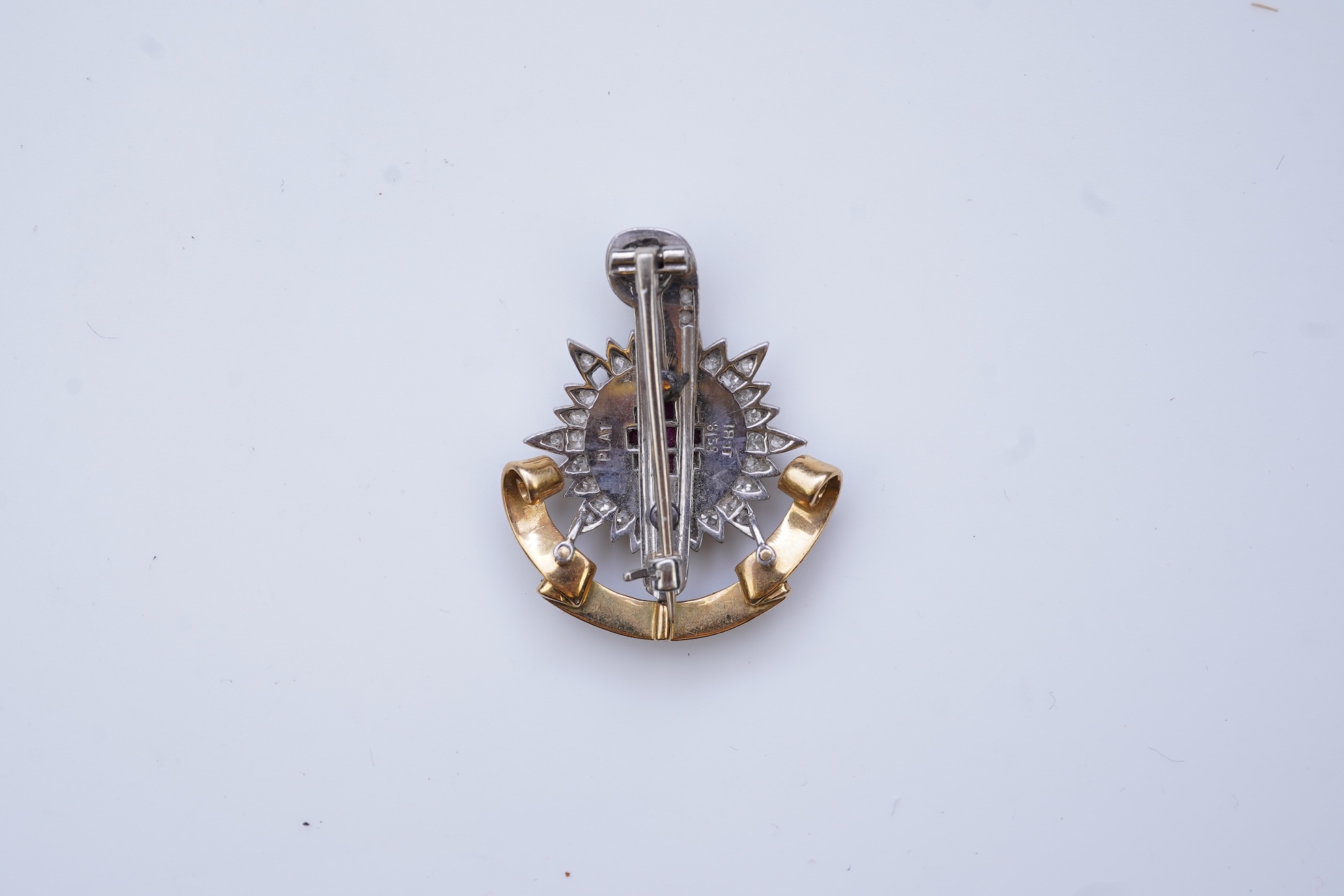 A ruby, enamel and diamond Royal Sussex Regiment badge, mid 20th century